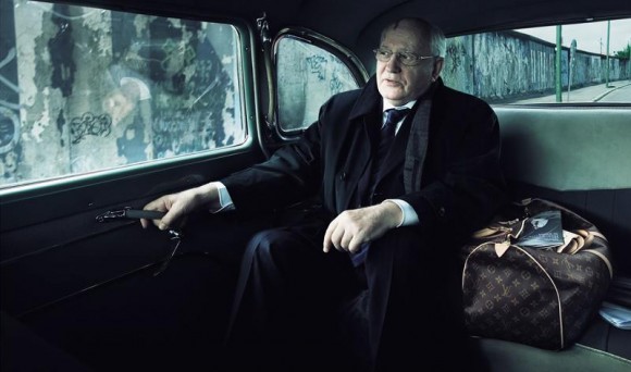 El político ruso Mijaíl Gorbachov dentro de un automóvil con los restos del muro de Berlín al fondo.