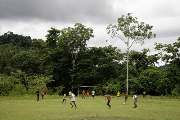 Boys plays soccer at a field surrounded by the jungle in San Josesito.