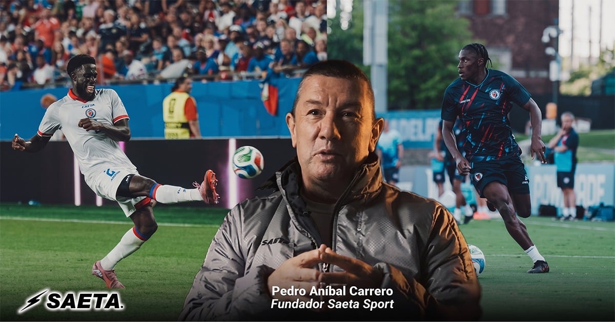 Portrait of Pedro Aníbal Carrero, founder of Saeta Sport, seated on a soccer field with players in the background; Saeta logo bottom left. - El boyacense que pasó de vender dulces a vestir la selección de Haití con Saeta y llegar a un Mundial