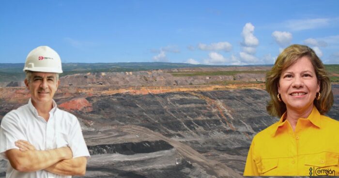 Two professionals stand at a large open-pit mine, man in a white shirt and hard hat, woman in a yellow blouse, blue sky behind. - Las2orillas.co: Historias, voces y noticias de Colombia