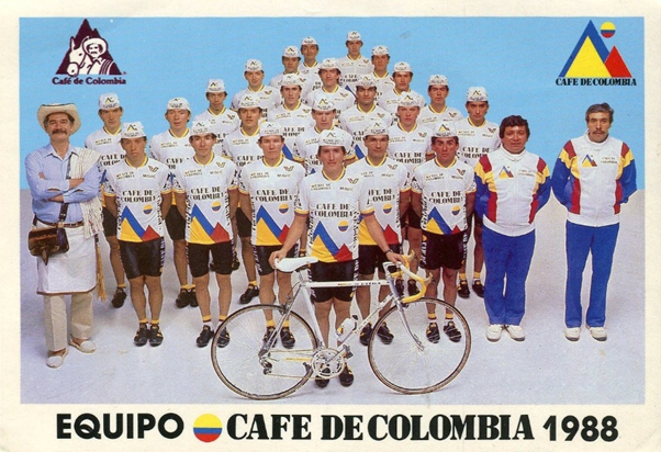 Team photo of Café de Colombia cycling team 1988: riders in white jerseys with Colombian flag accents, standing behind a front rider with a bicycle; two men in team gear on the sides. - La jugada de Germán Bahamón para traer de vuelta Café de Colombia con equipo de ciclismo de talla mundial