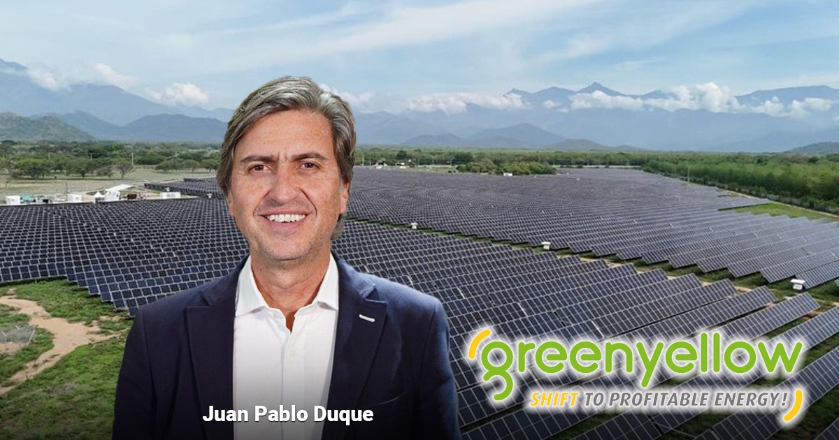 Juan Pablo Duque standing in front of a vast solar farm, with the GreenYellow logo and the slogan 'SHIFT TO PROFITABLE ENERGY!' in the foreground. - Los franceses de Green Yellow entran con fuerza en las granjas solares del país
