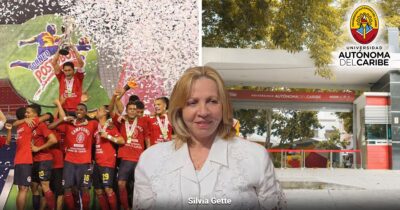 Soccer players in red celebrate with medals and confetti as a woman in a white jacket smiles in front of the Universidad Autónoma del Caribe entrance. - Uniautónoma F.C. el equipo que naufragó en medio de la crisis de la Universidad Autónoma del Caribe