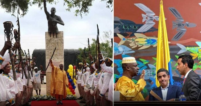 Ceremonial scene: guards in white uniforms raise rifles around a statue while a central figure in orange robes stands on a red carpet. - Un líder afro que avaló al papá de Miguel Uribe no quiso perderse la palomita de ser congresista por un mes