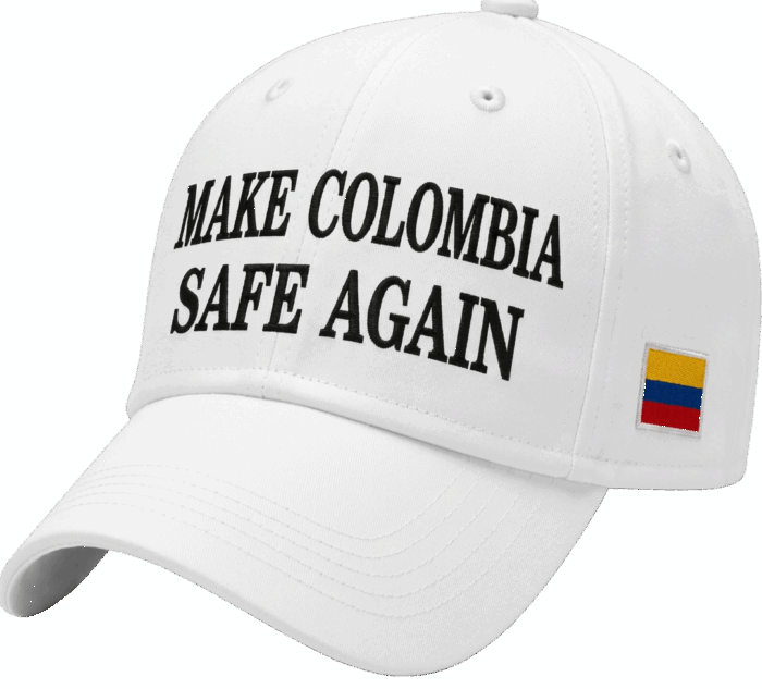 White baseball cap with the slogan 'Make Colombia Safe Again' in bold black letters and a small Colombian flag patch on the side. - Las gorras de Abelardo que ya son un negociazo en Miami por la masiva compra de sus fans