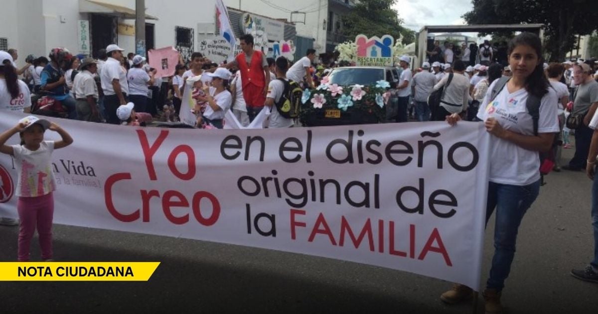 Group of people marching in a street parade, holding a large banner that reads 'Yo Creo en el diseño original de la FAMILIA'. - La tal "ideología de género" no existe; es un invento de los políticos y los grupos religiosos