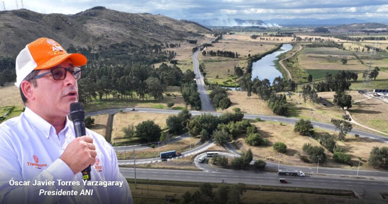 Las2orillas.co: Historias, voces y noticias de Colombia Man in an orange cap and white shirt speaks into a microphone, with a rural highway interchange and valley landscape in the background. - Las2orillas.co: Historias, voces y noticias de Colombia