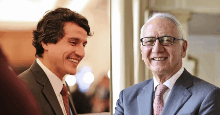 Smiling younger man in a gray suit on the left and an older man with glasses in a gray suit on the right at a formal event. - Quiénes están en los mejores oficinas de Procolombia en el exterior que El Tigre va a acabar