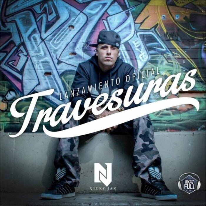 Promotional album cover showing a man in a backward cap seated against a colorful graffiti wall, with the bold script 'Travesuras' across the image. - La segunda oportunidad en Colombia que sacó a Nicky Jam de la pobreza y lo volvió un gigante del reguetón