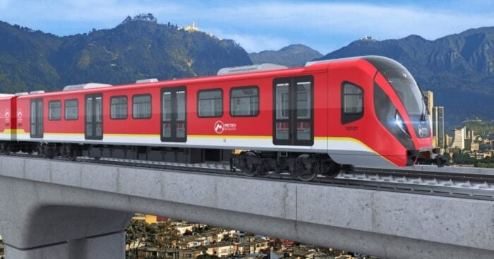 Red Bogotá metro train on an elevated track with mountains in the background - Que hicieron y que dejaron de hacer los 3 presidentes y 4 últimos Alcaldes de Bogotá por el Metro