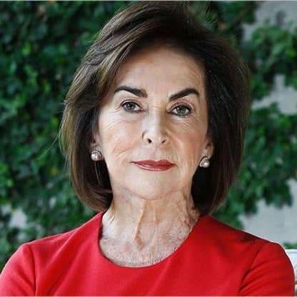 Los negocios que llevaron a la cima a los cinco más ricos de América Latina entre los que hay un colombiano Portrait of a mature woman with short brown hair wearing a red blouse, looking at the camera outdoors. - Los negocios que llevaron a la cima a los cinco más ricos de América Latina entre los que hay un colombiano
