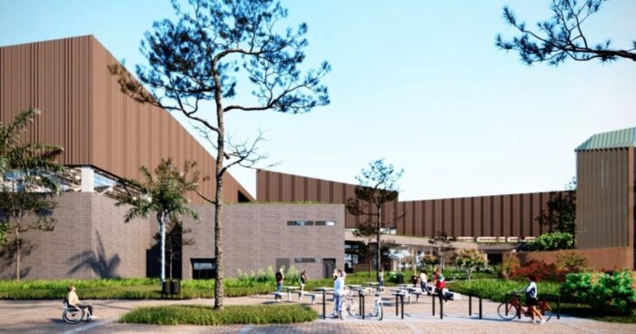 Después de diecisiete años y nueve contratos por más de .000 millones la Unidad Deportiva Salitre sigue igual Modern campus plaza with brown brick buildings, trees, and people walking, biking, and chatting outdoors under clear skies. - Después de diecisiete años y nueve contratos por más de .000 millones la Unidad Deportiva Salitre sigue igual