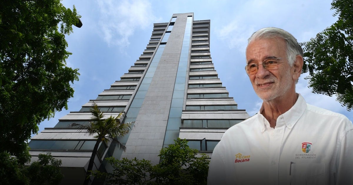 Tall modern high-rise building viewed from ground level with trees, plus an older man in a white shirt standing at the right foreground. - El edificio en Barranquilla que fue de los Nasser y hoy el gobernador Verano de la Rosa quiere volver centro de IA